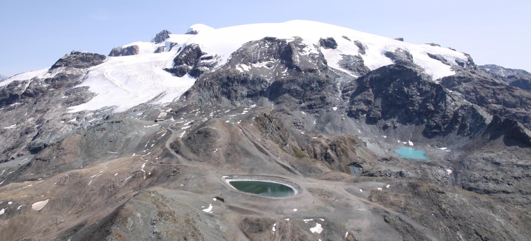 Panorama a est con Piccolo Cervino, Breithorn Occidentale e Gobba di Rollin che sovrastano il Colle Superiore delle Cime Bianche (con bacino artificiale) e il Lago della Punta di Rollin.